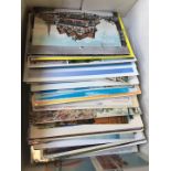 A box with quantity of various vintage postcards to include topographic, black & white, etc