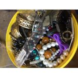 A tub of misc vintage and modern jewellery to include bangles, bracelets, necklaces, etc