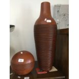 A large terracotta vase and a round terracotta ball ornament