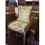 A reproduction walnut chair with floral upholstery