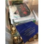 A box of coins, banknotes and military badges