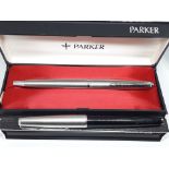 Two vintage Parker fountain pens with boxes.
