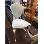 A cast metal framed salon chair
