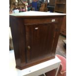 A mahogany corner cabinet