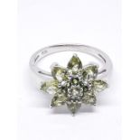 A silver cluster ring set with green stones, marked '925', size V, with box.