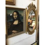 A reproduction classical style mirror and a print of the Mona Lisa...