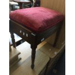 A mahogany piano stool with turned legs with sewing items inside