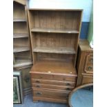 A walnut chest of drawers with bookcase top