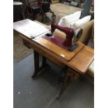A Singer treadle sewing machine with red sewing machine
