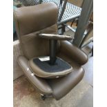 A brown leather reclining swivel chair with stool