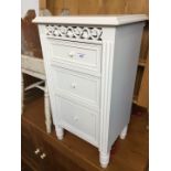 A modern white bedside cabinet