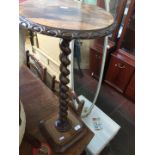 A rosewood twist pillar plant stand