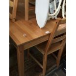 An Ikea pine dining table and 4 chairs