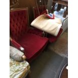 A pair of reproduction walnut armchairs with red button backed upholstery