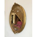 A gilt framed oval mirror