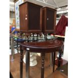 A pair of speaker cabinets and a demi lune table