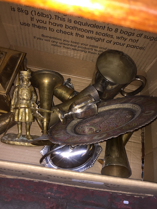 A box of brass and metal ware.