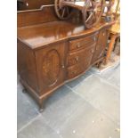 An oak sideboard with rail back