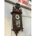 A Vienna wall clock - with key and pendulum