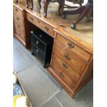 A reverse breakfront walnut cross banded partners desk with tooled leather top