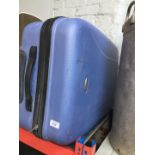 A hard shell luggage case on wheels