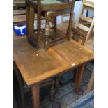 An oak drawer leaf table and 4 chairs