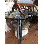 A glass and chrome dining table