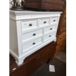 A white sideboard/chest of drawers