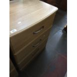 A modern light wood effect low chest of 3 drawers