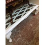 A glass top white painted coffee table