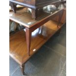 A teak coffee table and matching smaller table
