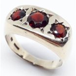 A hallmarked 9ct gold three stone garnet ring, gross wt. 5.2g, size Q.