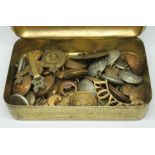 A WWI 1914 Christmas tin containing various military buttons and badges.