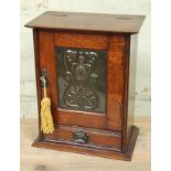 An oak smoker's cabinet circa 1900 with Arts & Crafts style copper panel, height 39.5cm.