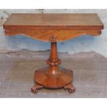 A William IV rosewood fold over card table, tooled leather interior, turned pedestal with round