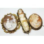 A group of three yellow metal mounted cameo brooches.