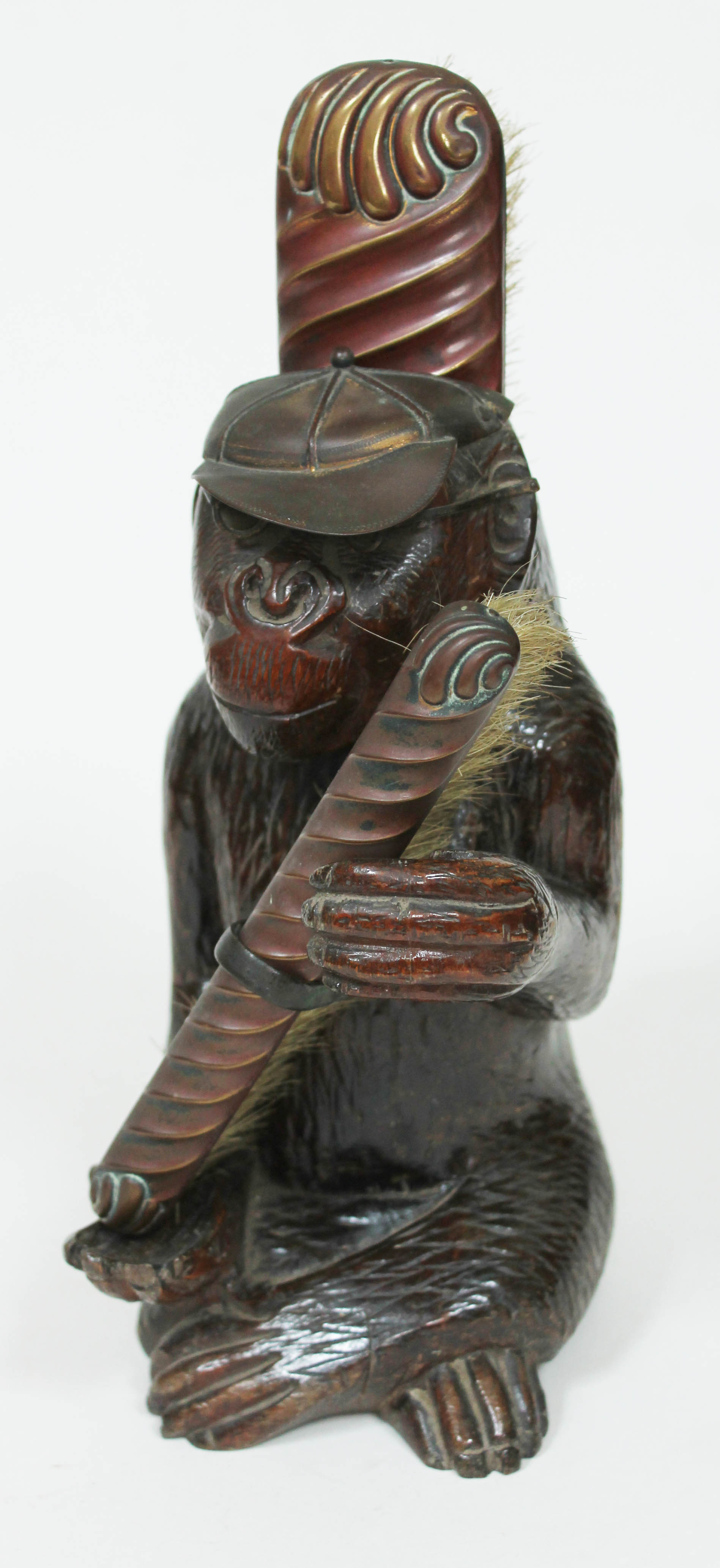 A novelty carved wooden brush holder circa 1900, formed as a chimpanzee wearing a schoolboy cap