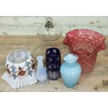 A mixed lot of glass comprising a glass lamp protector, two glass shades, a blue cased etched