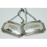 A pair of hallmarked silver decanter labels.