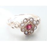 An 18ct gold ruby and half cut pearl cluster ring, marked '18K', gross wt. 2.4g, size L.