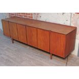 A 1960s Danish style teak sideboard, length 228.5cm, depth 51cm & height 76cm.