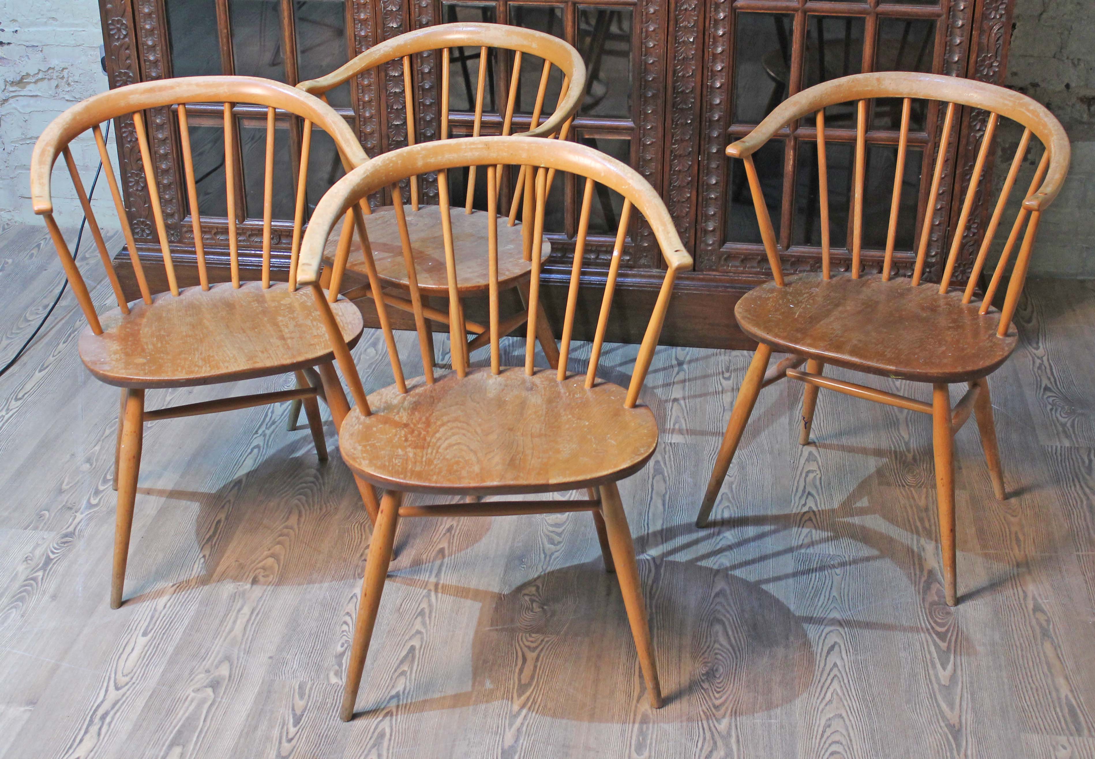 A set of four Ercol elm seated spindle back cow horn armchairs.