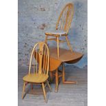 An Ercol blonde elm and beech Campden 955 drop leaf table and two swan back chairs.