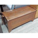 An oak bedding chest with pegged joints to lid and carved detail to front, length 105cm.