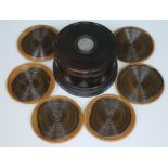 A set of six lignum vitae coasters with cylindrical box, the lid inset with a George IV coin.