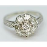 An 18ct white gold diamond cluster ring, marked '18ct PLAT', gross wt. 4.4g, size L.