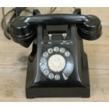 A black bakelite telephone.