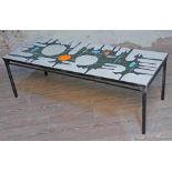 A retro abstract tile top coffee table, length 122.5cm. Condition - various cracks to tiles.