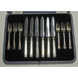 A cased set of hallmarked silver cake forks and silver handled knives.