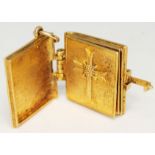 A hallmarked 9ct gold charm formed as The Holy Bible, length 28mm, wt. 11.9g.